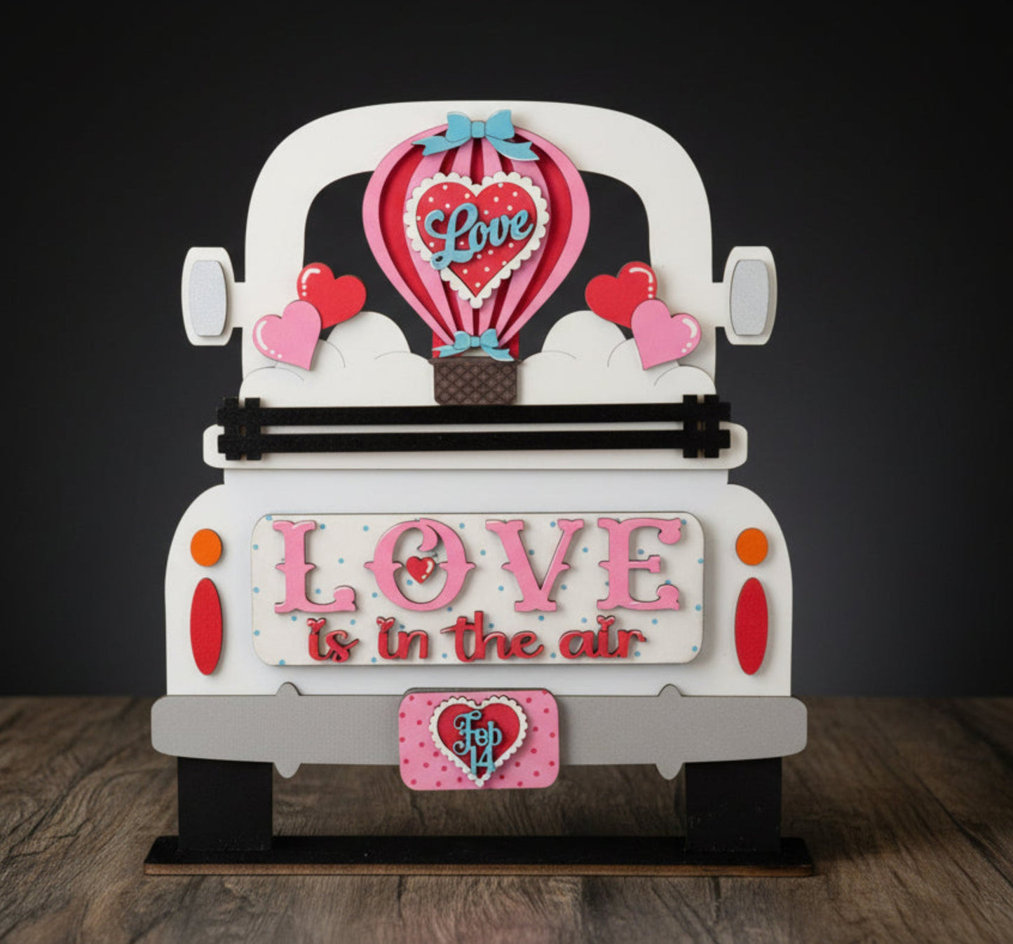 Decorative sign with 'Love is in the air' text, hot air balloon and heart designs on a white background. An interchangeable wood insert for our Farmhouse Truck sign or shelf sitter.