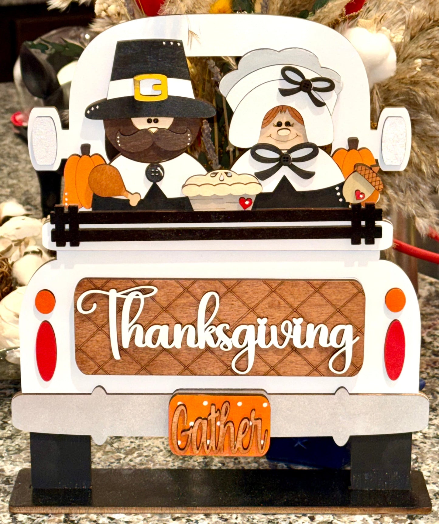 Decorative pilgrims with a pumpkin, pie & turkey leg, featuring the word 'Thanksgiving' and the word 'Gather’ interchangeable wood insert for our Farmhouse Truck Sign or Shelf Sitter. 