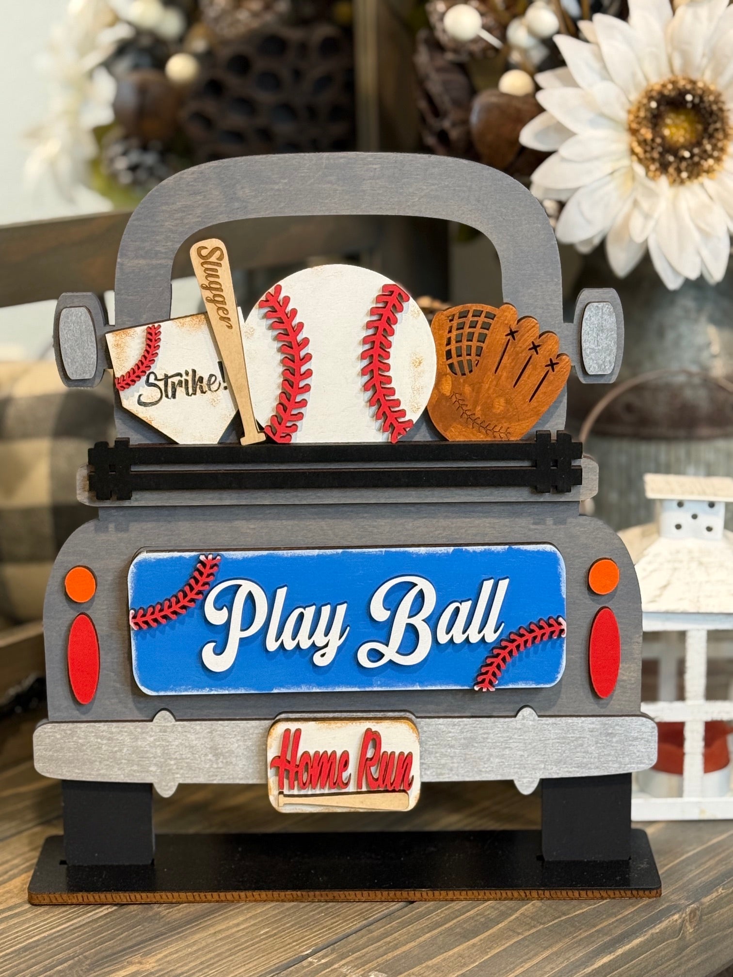 Wooden farmhouse truck sign filled with a baseball, a "Slugger" bat, and a glove, featuring a blue "Play Ball" tailgate and "Home Run" license plate interchangeable insert.