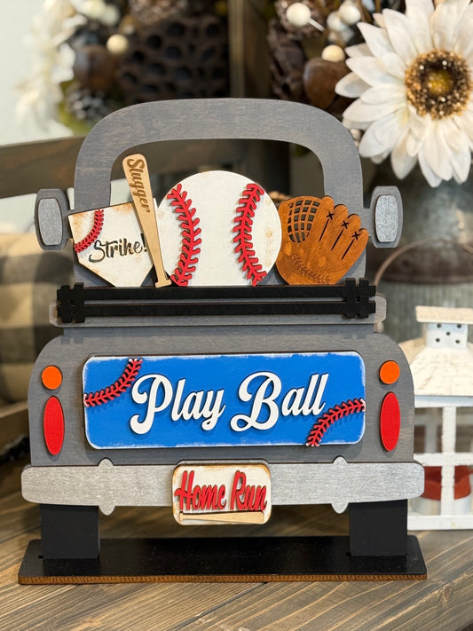 Wooden farmhouse truck sign filled with a baseball, a "Slugger" bat, and a glove, featuring a blue "Play Ball" tailgate and "Home Run" license plate interchangeable insert.