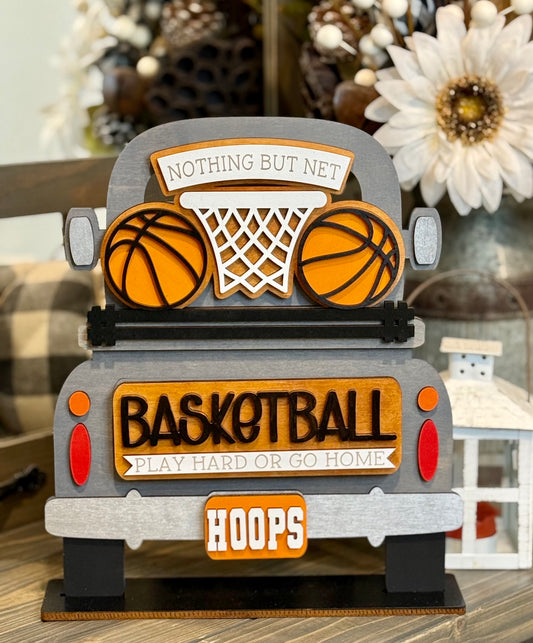 A hand painted farmhouse wooden truck sign with an interchangeable insert that has two basketballs and a hoop, with a tailgate that reads "Basketball: Play Hard or Go Home."