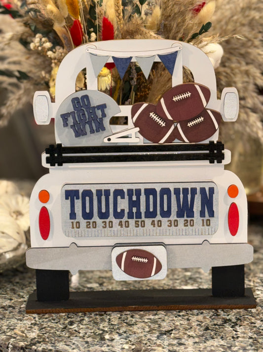 Decorative football wood sign with 'Go Fight Win' and 'Touchdown' text painted to your favorite team colors. It's an interchangeable insert for our Farmhouse Truck sign or shelf sitter.