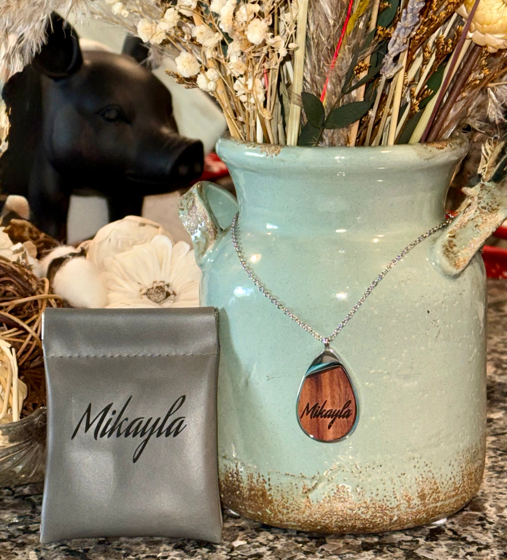 Necklace with wooden pendant and able to personalize laser engraving on the wood pendant. Includes leather pouch.